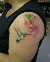 hummingbird and flower pic tattoo on left arm